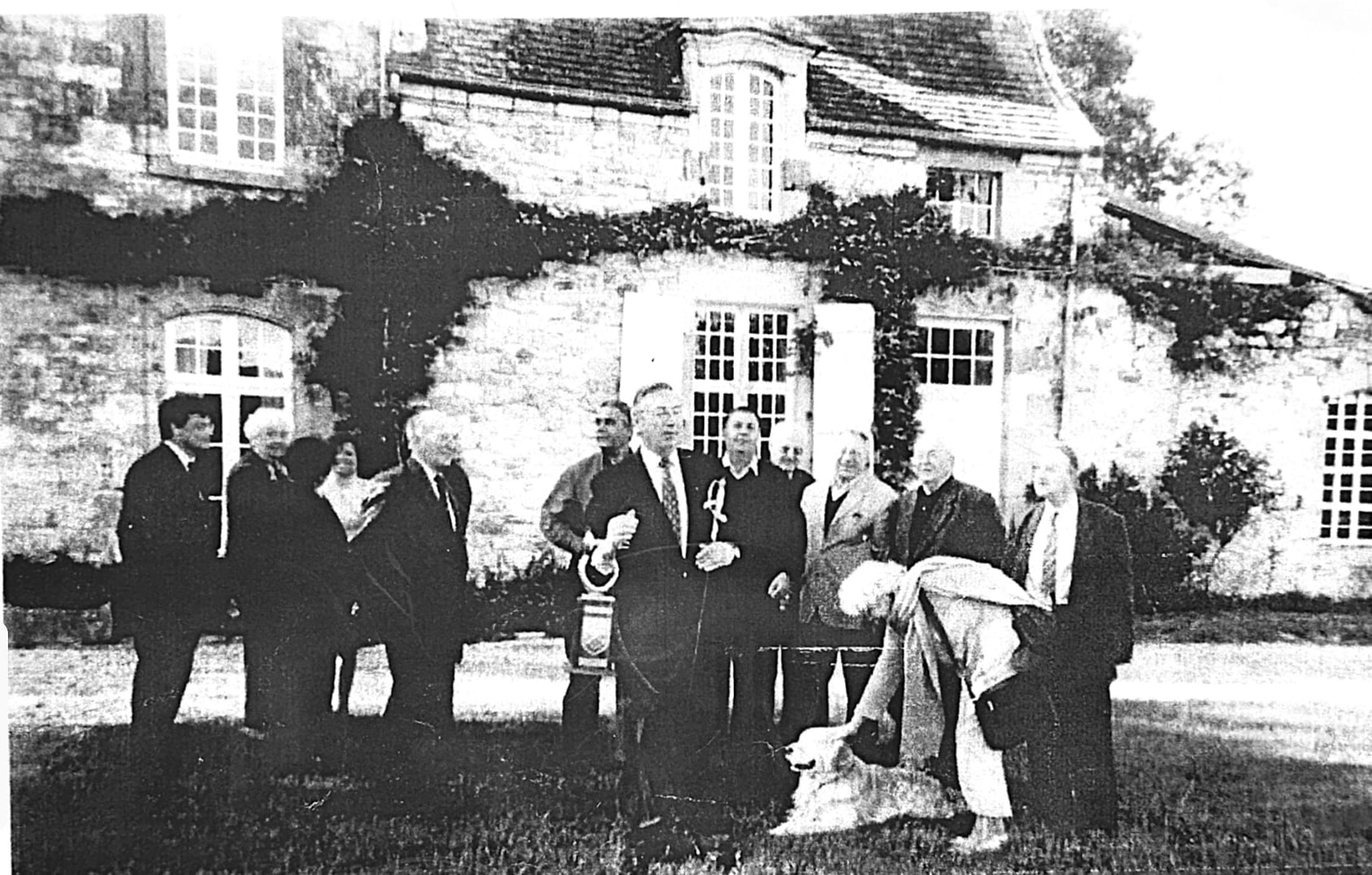 Historical Rosse family gathering outside a large house